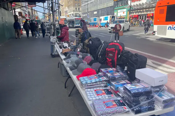 A table lined with goods for sale.